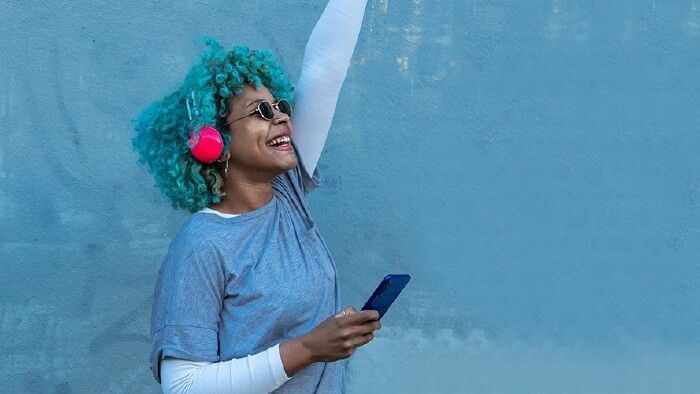 happy young woman with headphones and mobile phone